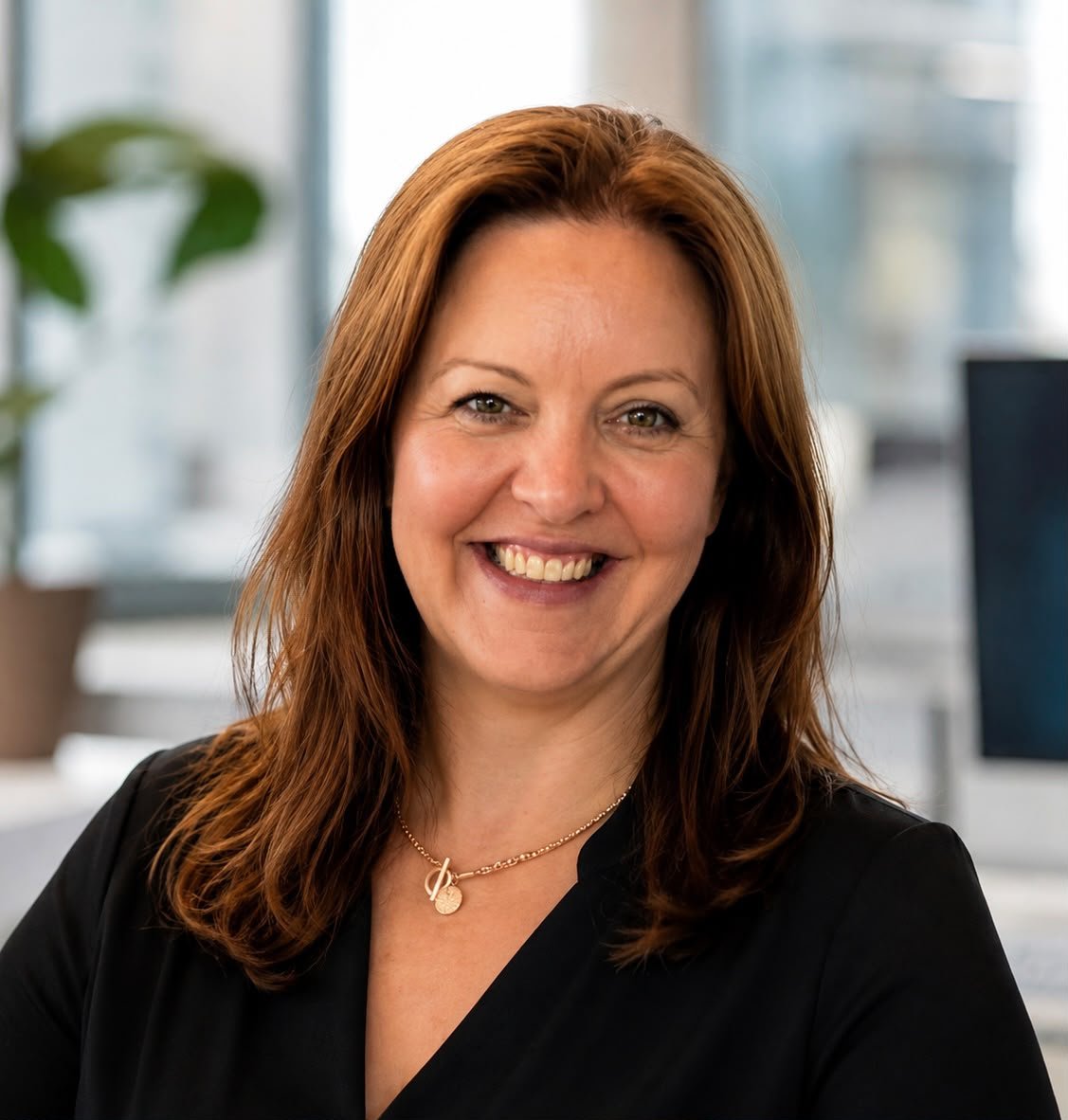 Eva Murphy PhD, Co-Founder and CTO of Social Jam, smiling in an office